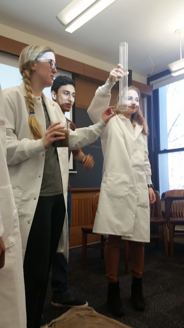 Steph, Amar, Natalie (left to right), and Kalisa (not in picture) explains the function of a secchi disk for turbidity measurements